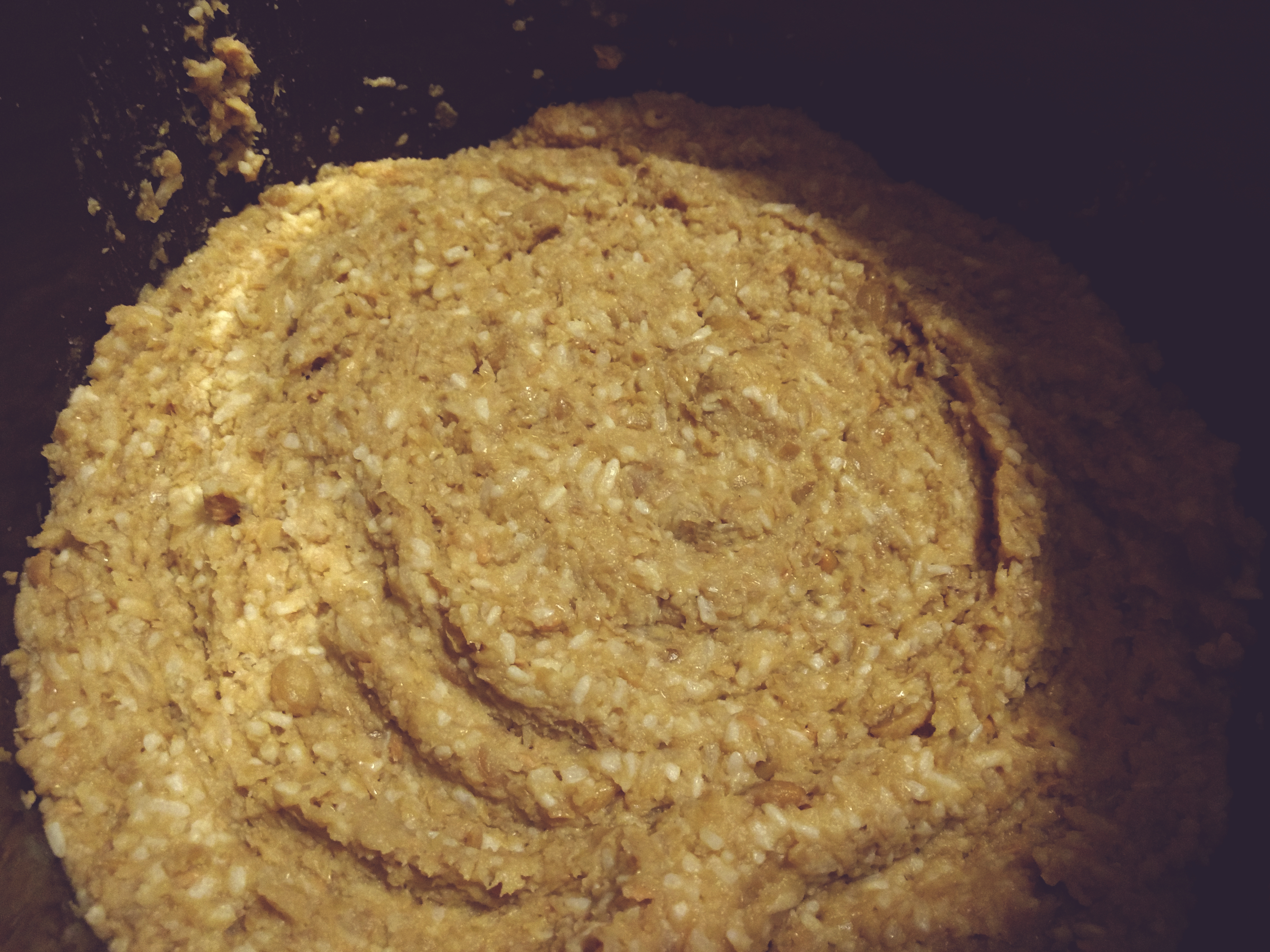 a closeup view of the impact-rippled surface of miso in a crock